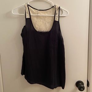 Black small size tank top with white lace detail.